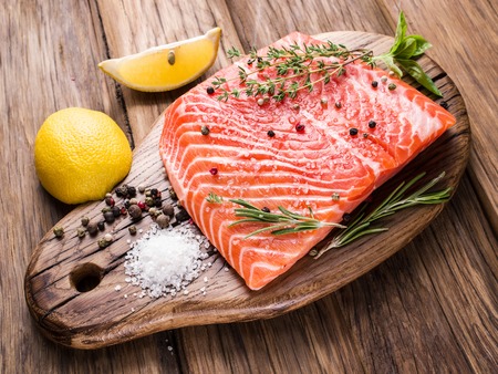Fresh salmon on the cutting board. Cooking process.の写真素材