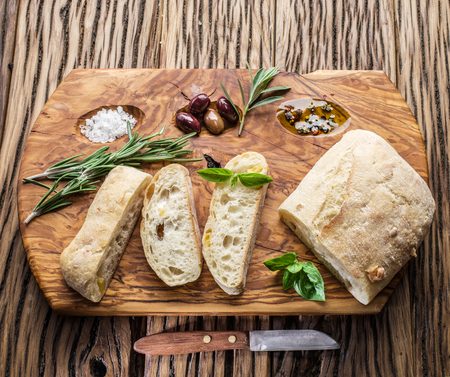 Ð¡iabatta, olives and blue cheese on the wood.の写真素材