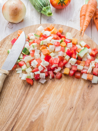 Fresh cut vegetables on the wooden chopping board.の写真素材