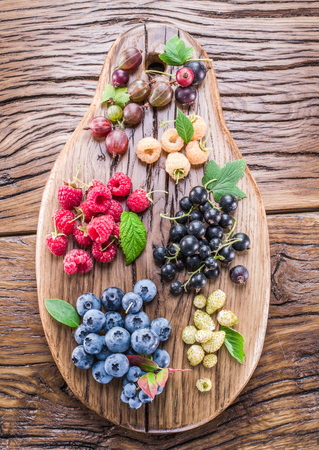 Ripe berries on the old wooden plank.の写真素材