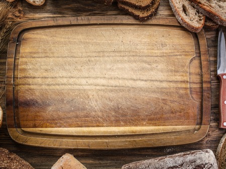 Sliced black bread on the old wooden plank.の写真素材