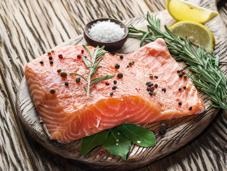 Fresh salmon on the cutting board. Cooking process.の写真素材