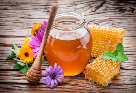 Jar full of fresh honey and honeycombs. High-quality picture.の写真素材