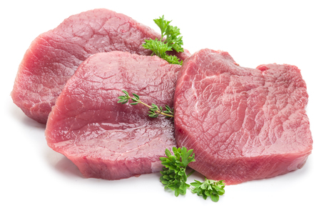 Raw beaf steaks with parsley on a white background.の写真素材