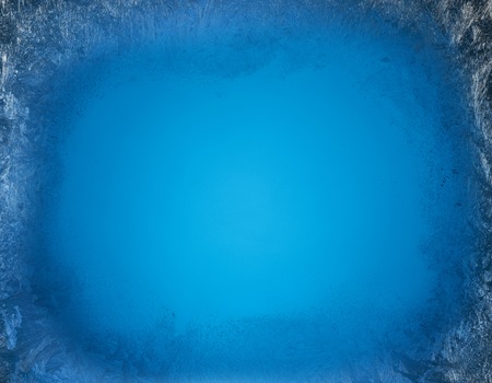 Frosty patterns on the edge of a frozen window.の写真素材