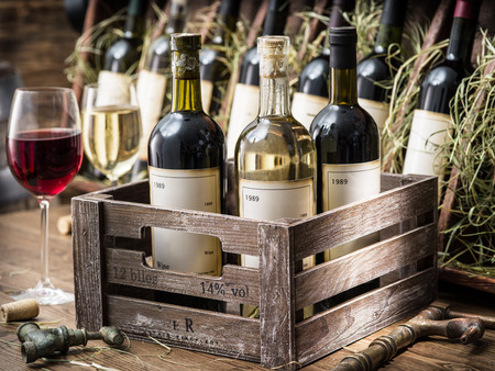 Old wine bottles in a wooden crate.の写真素材
