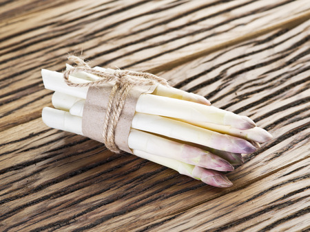 Shoots of white asparagus on the old wooden table.の写真素材