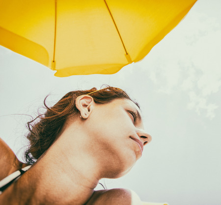 Woman enjoying warm summer day at the seaside. Vintage style.の写真素材