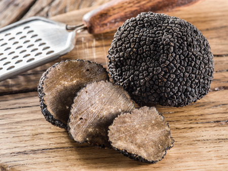 Black truffles on the old wooden table.の写真素材