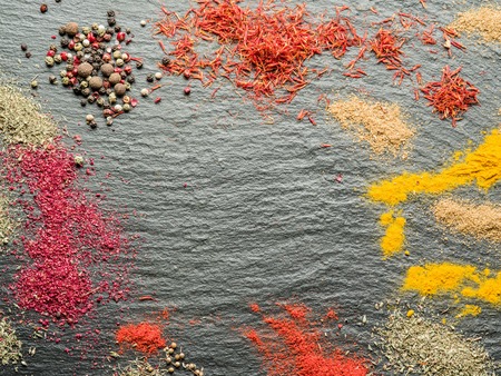 Assortment of colorful spices on the graphite background.の写真素材