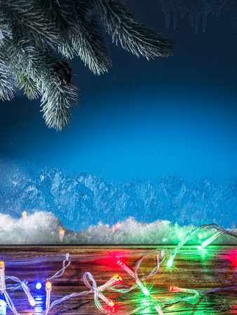 Christmas lights and frozen window. Christmas background.の写真素材