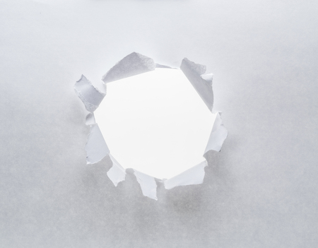 Hole on a paper. White background.の写真素材