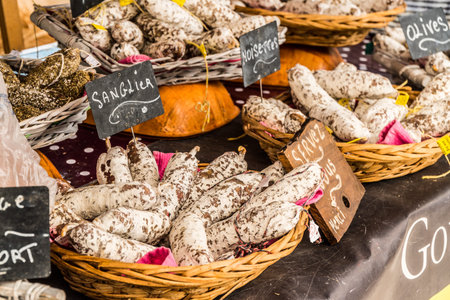 Variety of dry cured sausage products and meat.