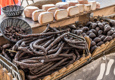 Variety of dry cured sausage products and meat.