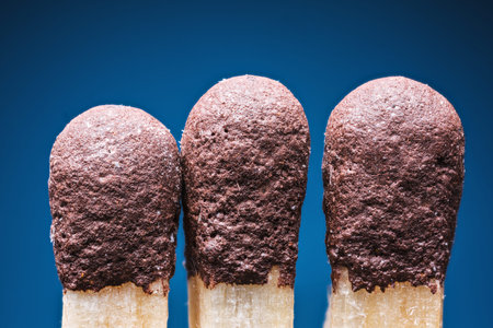 Safety match with brown head. Blue background.