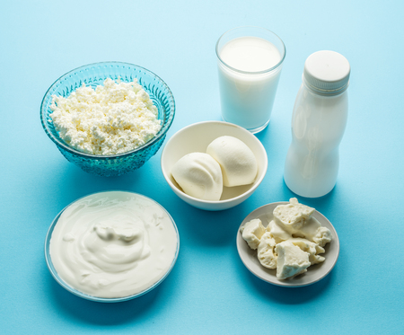 Protein products: cheese, cream, milk, eggs on the blue background. Top view.の写真素材