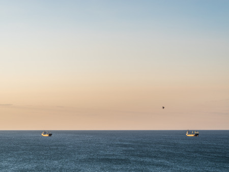 Calm sea and cloudless orange evening sky.の写真素材