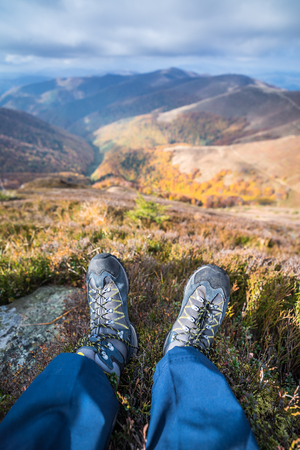 Hiker's boots and the mountain peaks at the background.の写真素材