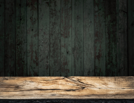 Old wooden tabletop and wooden wall at the background.の写真素材