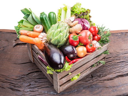 Fresh multi-colored vegetables in wooden crate.の写真素材