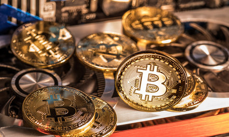 Shiny physical bitcoins and record-keeping equipment.