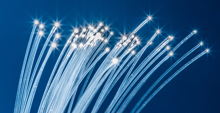 Bundle of optical fibers with lights in the ends. Blue background.の写真素材