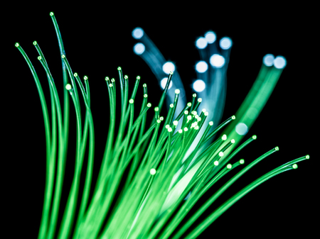 Bundle of optical fibers with green light. Black background.の写真素材