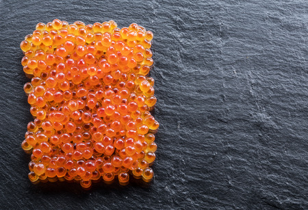 Red caviar on gray graphite background. Top view.の写真素材