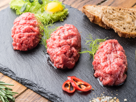 Steak tartare served with capers, pickled cucumbers and chopped onion.の写真素材
