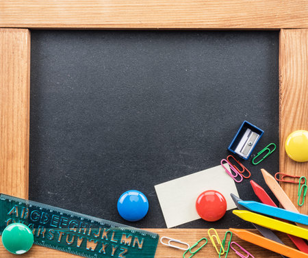 Blackboard and different school things. Close up.