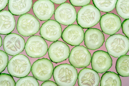 Cucumber slices isolated on the pink background.の写真素材
