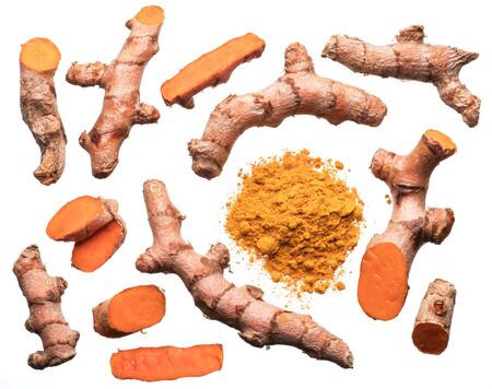 Fresh turmeric rhizome cuts and turmeric powder isolated on white background.の写真素材