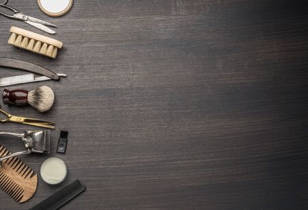 Classic grooming and hairdressing tools on wooden background. Top view on barbershop instruments  laying on dark wooden table.の写真素材