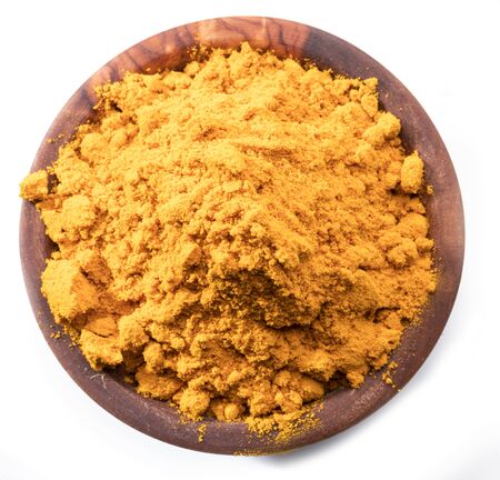 Turmeric powder or curcuma powder in wooden bowl isolated on white background.の写真素材
