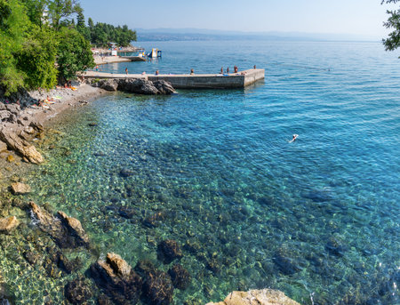 Stony coastline and transparent amazing water of the Adriatic Sea. Opatija resort, Croatia.
