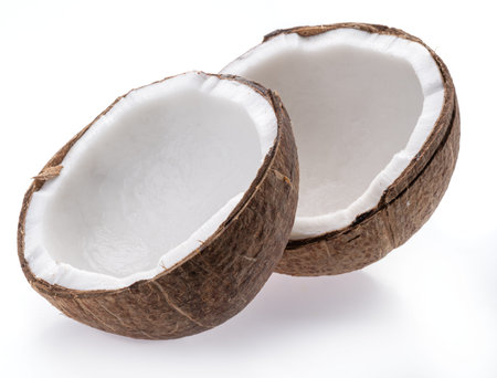 Split coconut fruit with white sweet flesh isolated on white background.