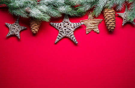 Red New Year or Christmas background with fir branch and christmas decor. Top view.の写真素材
