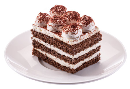 Slice of chocolate cake with tiramisu cream and cocoa powder on white plate isolated on white...