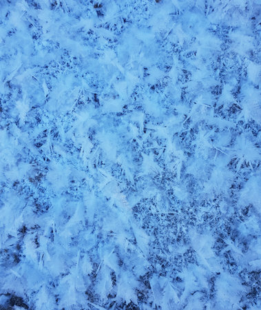 Snow crystal form beautiful snow pattern on frozen icy river.