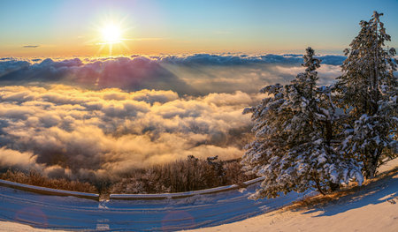 Sunrise shining over the clouds. Beautiful cloudscape and sunrise in thÑ mountains.の写真素材