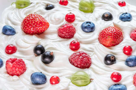 Mix of fresh berries in the yoghurt or cream. Top view.の写真素材