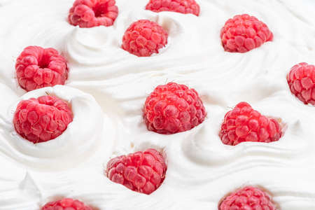 Fresh raspberries in the yoghurt or cream. Top view.の写真素材