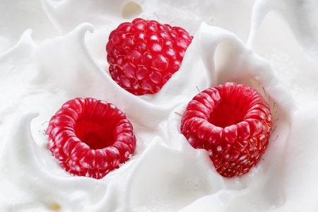 Fresh raspberries in the yoghurt or cream. Top view.の写真素材