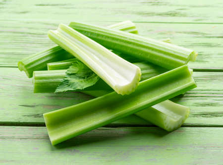 Pile of celery ribs isolated on white background.の写真素材