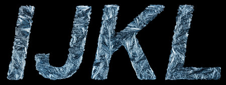 Part of the unique letters of the Latin alphabet - I, J, K, L in the form of frozen winter patterns isolated on a black background. Concept of the Christmas alphabet in frozen drawings.の写真素材