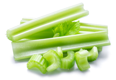 Pile of celery ribs and cuts isolated on white background.の写真素材