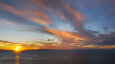 Breathtaking sunset in the calm ocean at the Cabo da Roca, Portugal.の写真素材