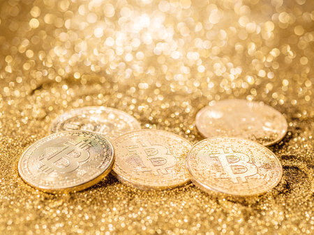 Gold bitcoin coins at the blazing gold background. Conceptual picture of digital money.の写真素材