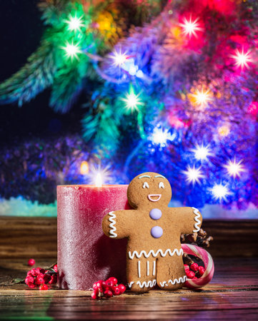 Candy cane, gingerbread Man and burning candle as the symbols of Christmas happiness and miracle.