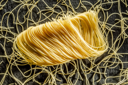 Italian pasta vermicelli close-up on black background. Food background.の写真素材